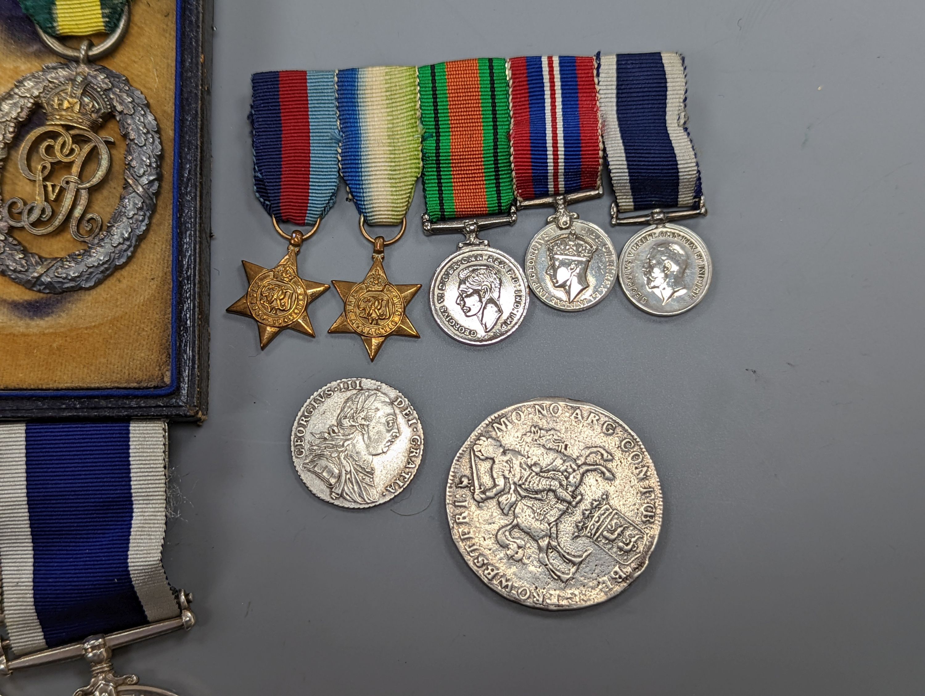 A WW1 group of four to MAJOR H. L. GREGORY R.A.M.C. and a WW2 Royal Navy group of five medals, including Royal Navy for long service and good conduct medal, unnamed, together with a 1787 shilling, good VF and another coi
